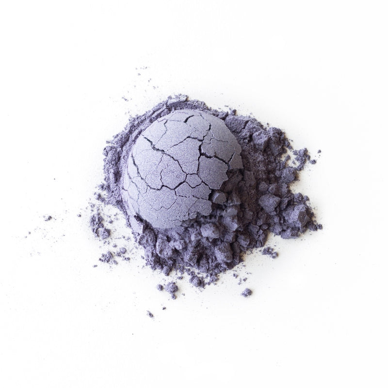 A purple Butterfly Pea Flower Lime Lemongrass powder on a white background by Rishi Tea & Botanicals.