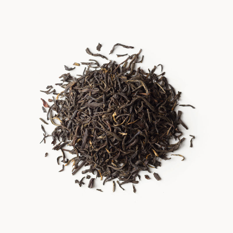 A pile of China Breakfast - Organic black tea by Rishi Tea & Botanicals on a white background.