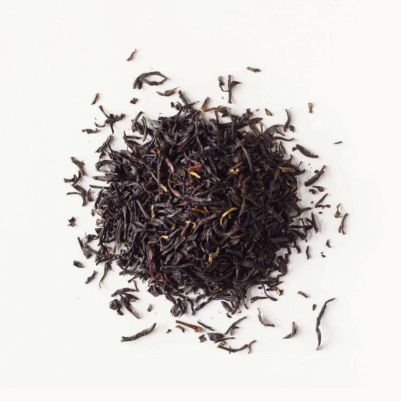 A pile of Earl Grey tea from Rishi Tea & Botanicals on a white background.