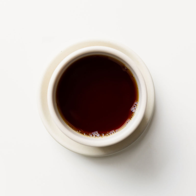 A cup of English Breakfast coffee on a white background by Rishi Tea & Botanicals.