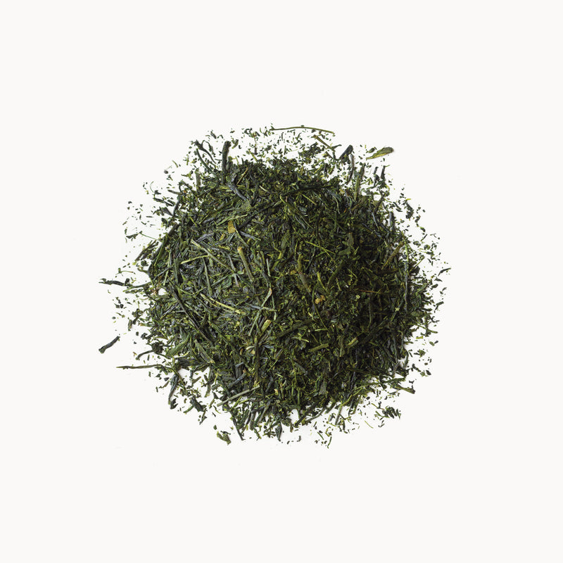 A pile of Sencha tea from Rishi Tea & Botanicals on a white background.