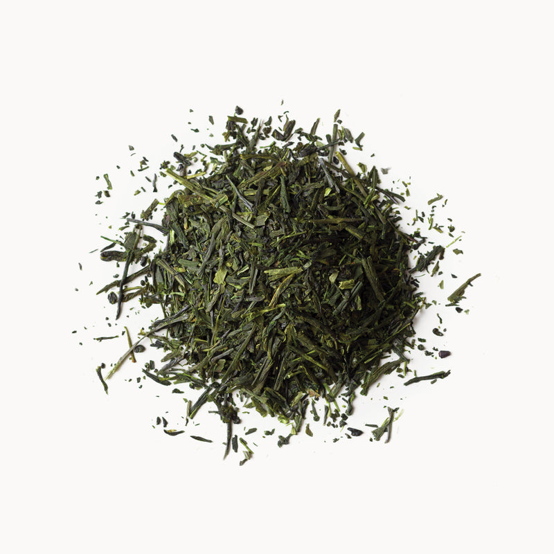 A pile of Sencha Superior green tea from Rishi Tea & Botanicals on a white background.