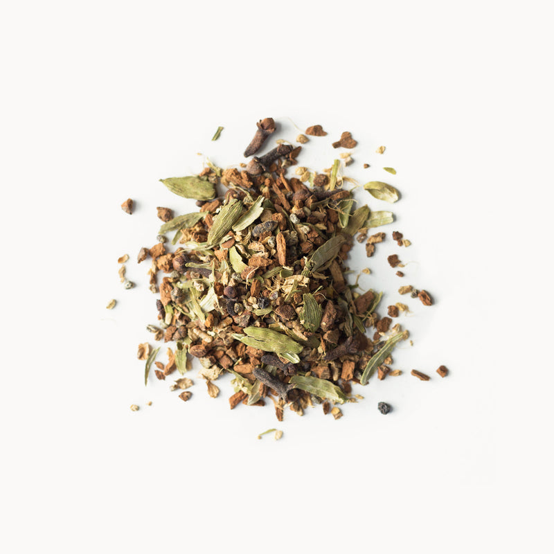 A pile of Rishi Tea & Botanicals' Spicy Masala Chai herbs and spices on a white background.